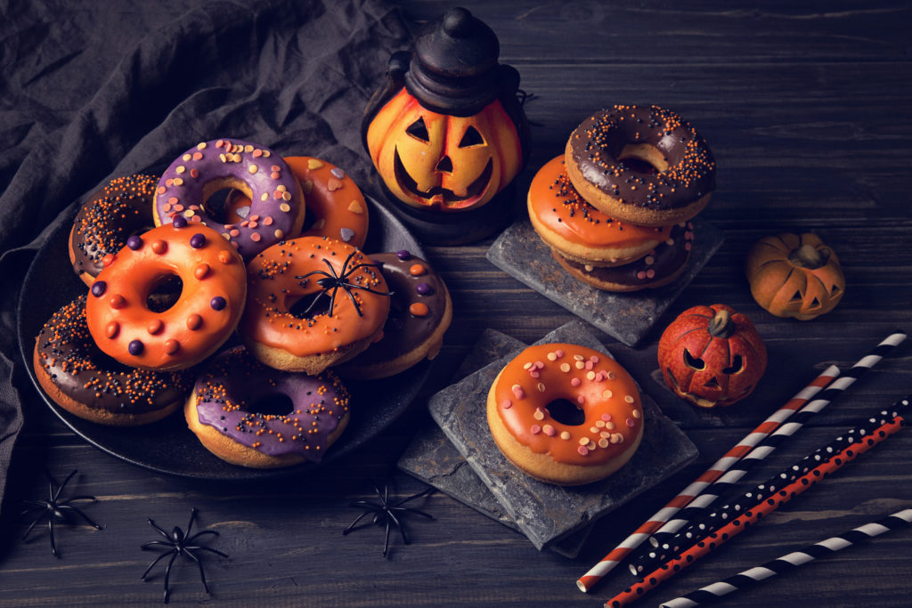 Halloween donuts on a dark wooden background