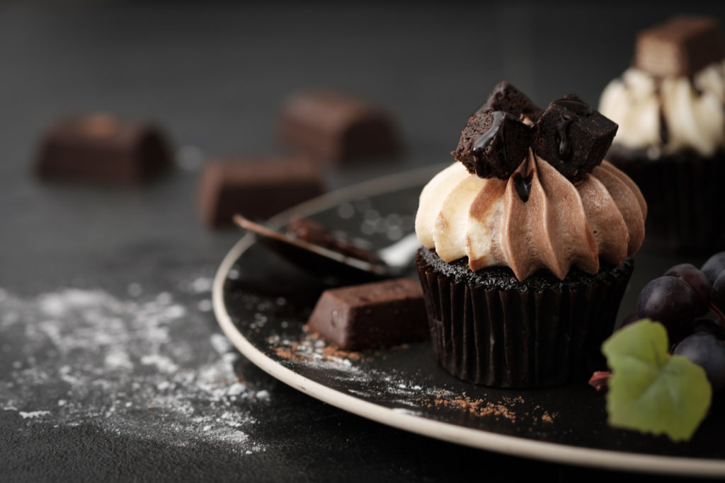 Chocolate cupcake with icing and chocolate bar