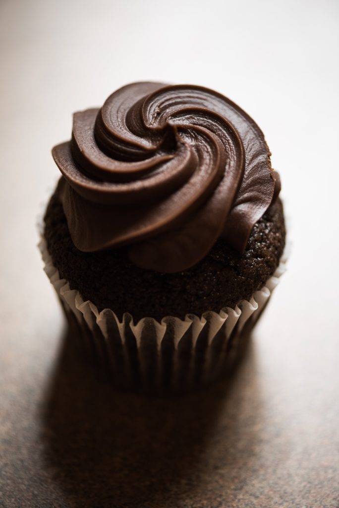 Close up image of a chocolate cupcake with frosting