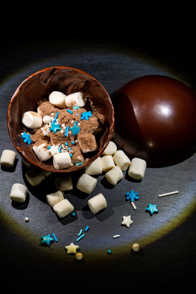 chocolate balls with cocoa and marshmallows in New Year's decoration